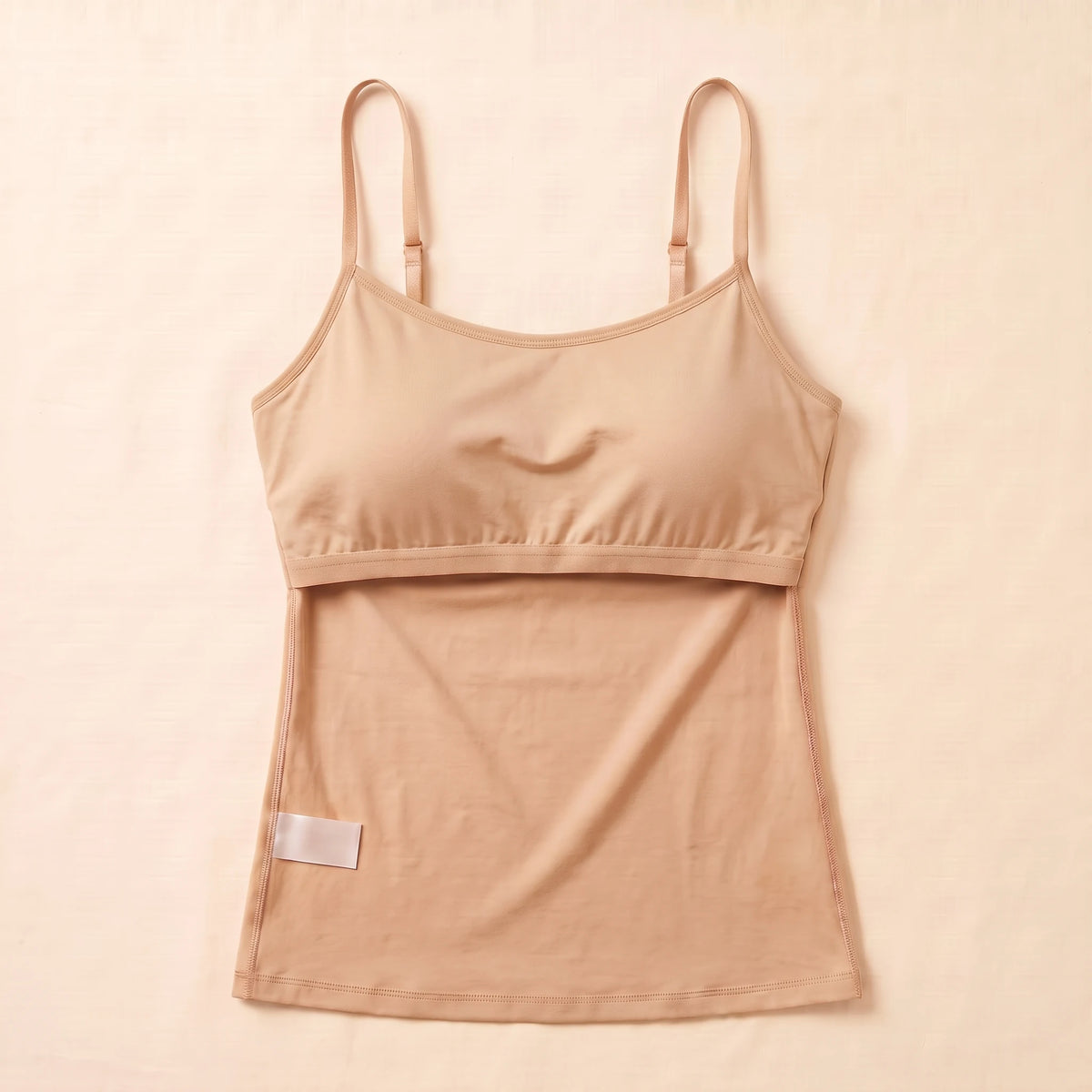 Inside of the Crème beige Kischt Aurelle tank top, turned inside out: the built-in shelf bra is fully covered by a smooth fabric lining with a soft elastic band