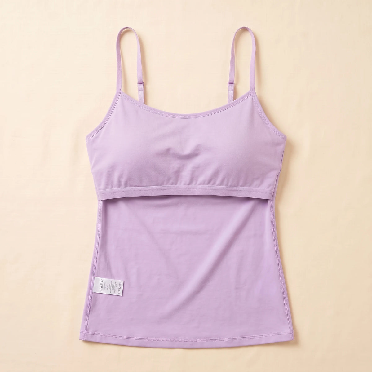 Inside of the Lilac lavender Kischt Aurelle tank top, turned inside out: the built-in shelf bra is fully covered by a smooth fabric lining with a soft elastic band