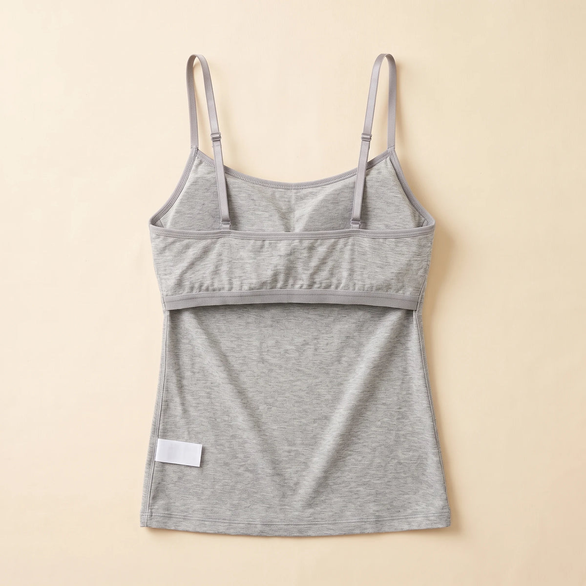 Inside of the Mist heather grey Kischt Aurelle tank top, turned inside out: the built-in shelf bra is fully covered by a smooth fabric lining with a soft elastic band
