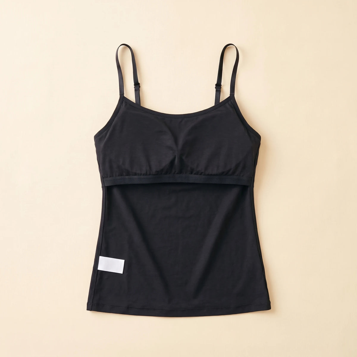 Inside of the Noir black Kischt Aurelle tank top, turned inside out: the built-in shelf bra is fully covered by a smooth fabric lining with a soft elastic band