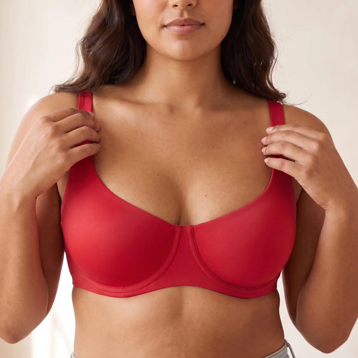 Close-up of the Cerise red Kischt Camille balconette bra lifting from underneath with smooth unlined cups and wide straps