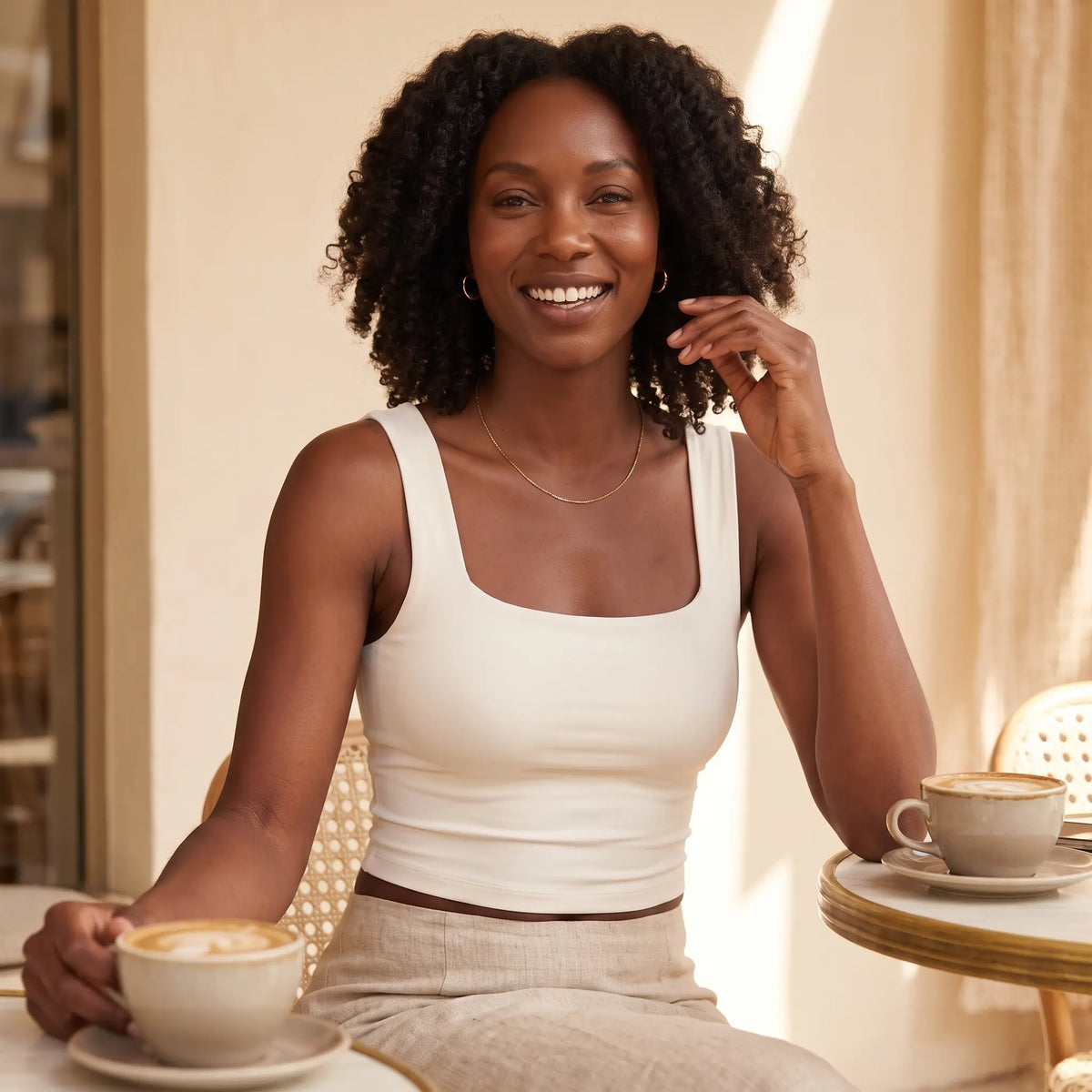 Woman at brunch in the Ivoire ivory Kischt Elodie square neck crop tank with built-in bra and a linen skirt