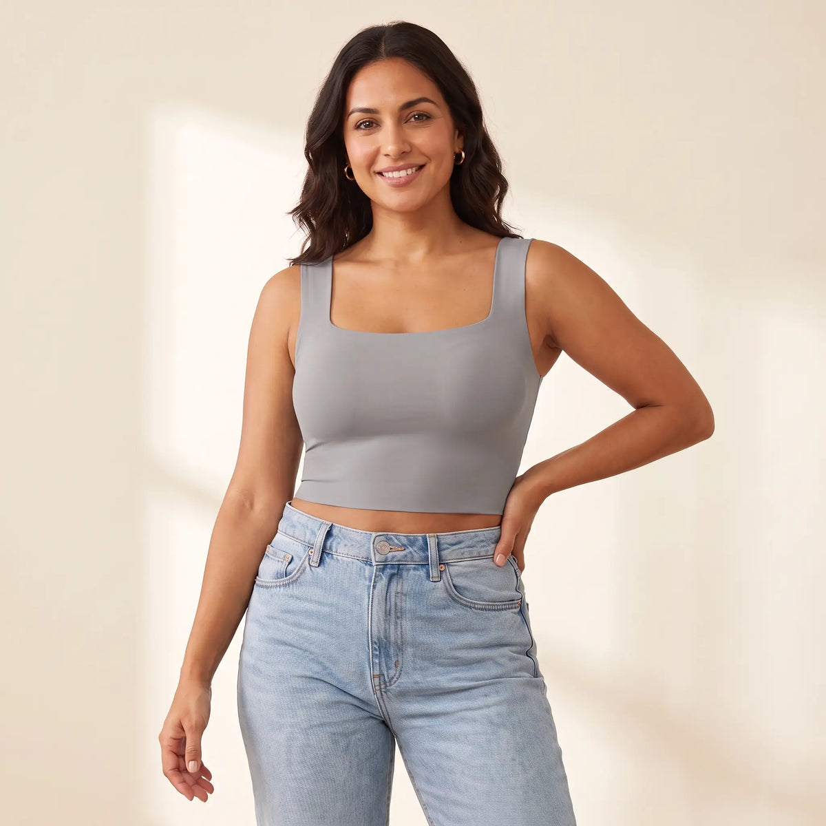 Woman in her 30s wearing the Kischt Elodie square neck crop tank top with built-in bra in Gris grey with high-waisted jeans