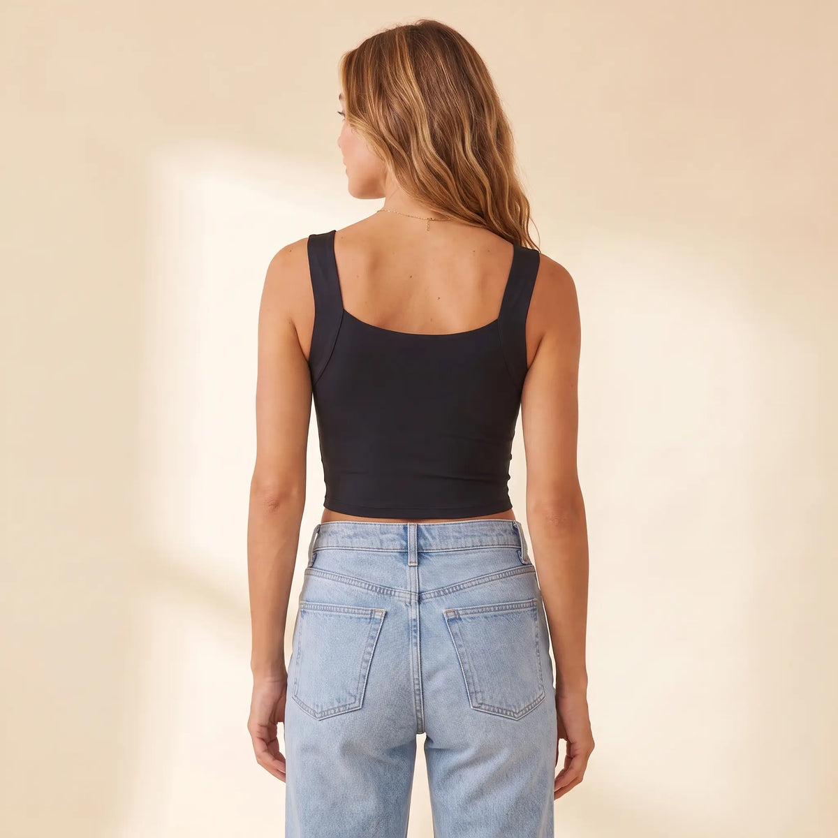 Back view of the Noir black Kischt Elodie square neck crop tank with wide straps and a smooth back with no bra lines