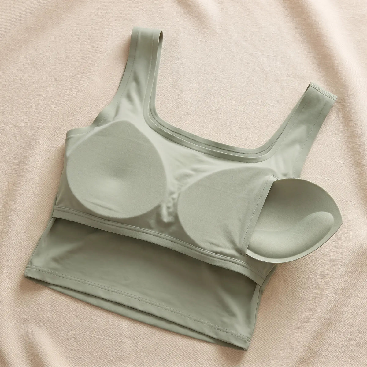 Inside of the Sauge sage green Kischt Elodie crop tank: a built-in bra lining with soft removable pads, no underwire