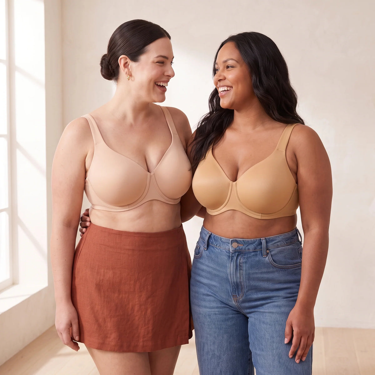 Two curvy women wearing Kischt Margaux full coverage unlined minimizer bras in Crème nude and Almond tan