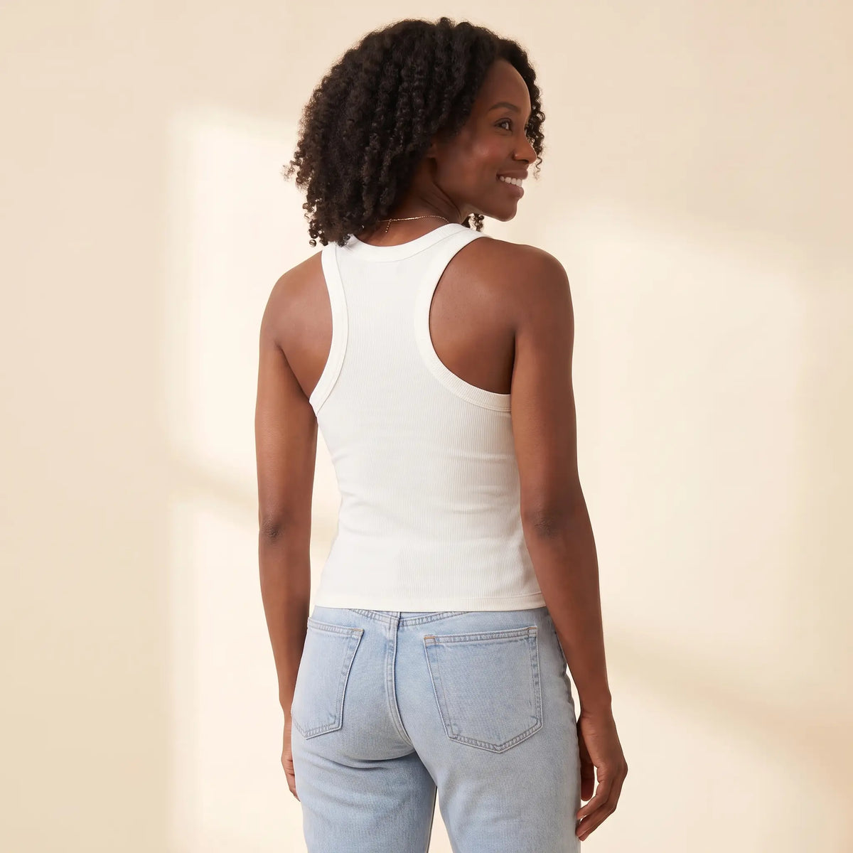 Back view of the Blanc white Kischt Noemi ribbed racerback tank top showing the racerback cut with no bra lines
