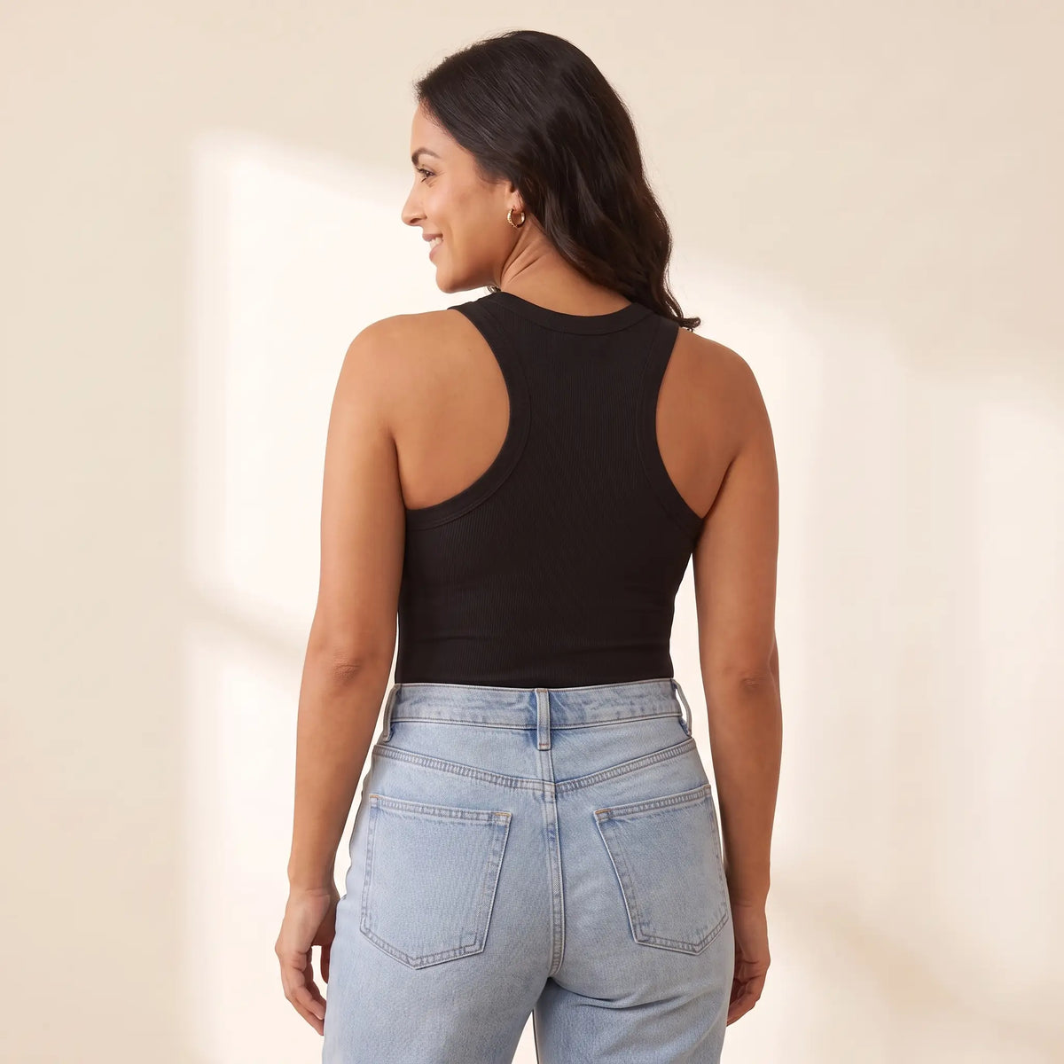 Back view of the Noir black Kischt Noemi ribbed racerback tank top showing the racerback cut with no bra lines