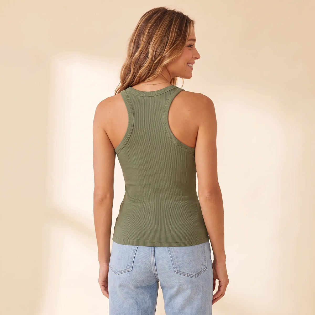 Back view of the Olive army green Kischt Noemi ribbed racerback tank top showing the racerback cut with no bra lines