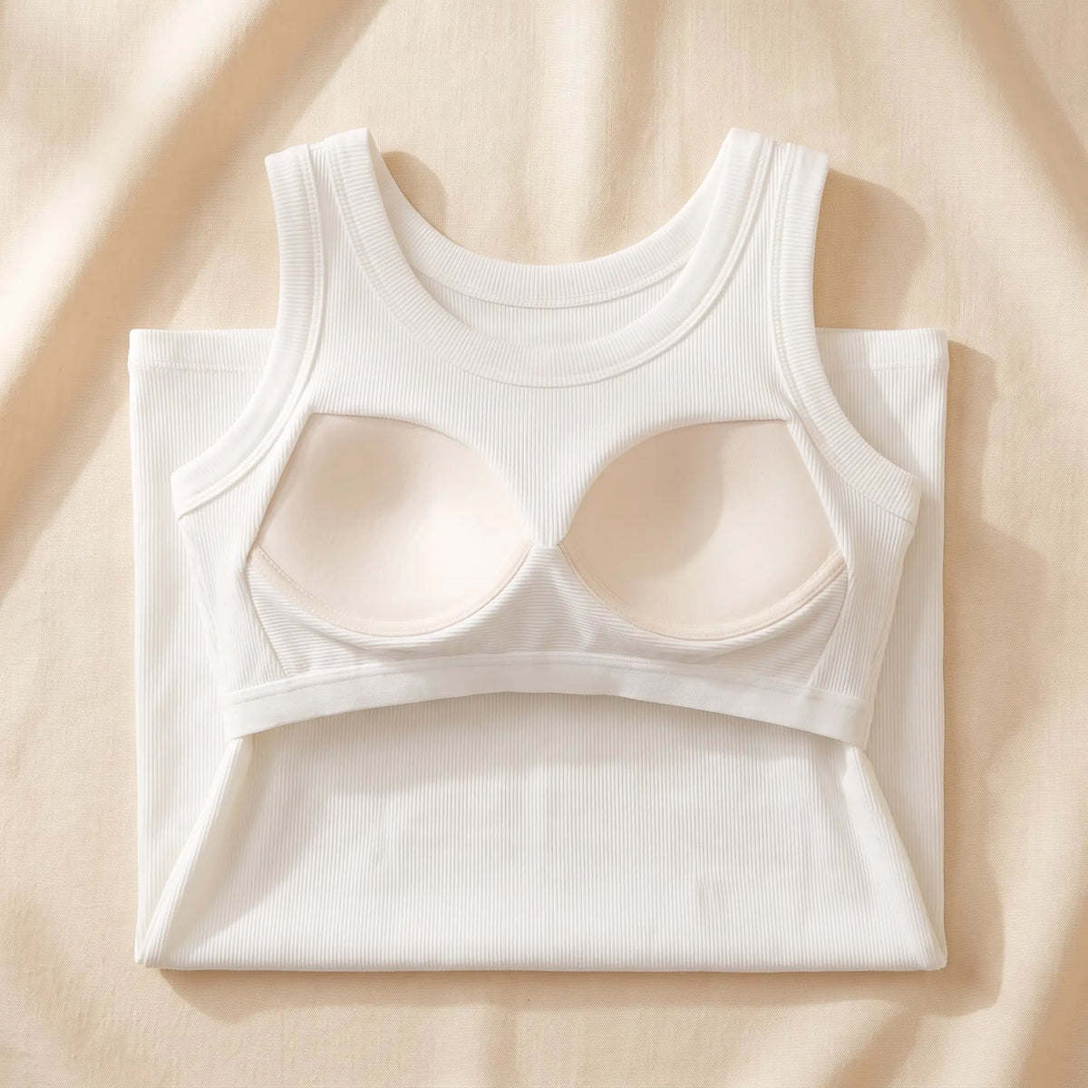 Inside of the Blanc white Kischt Solene ribbed tank top: a built-in shelf bra with soft padded cups on an elastic underbust band, no underwire